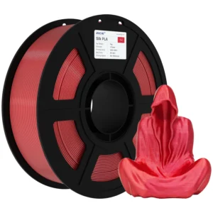 Red filament spool (PLA) on a black reel with a pair of red gloves in the foreground, showcasing 3D printing material.